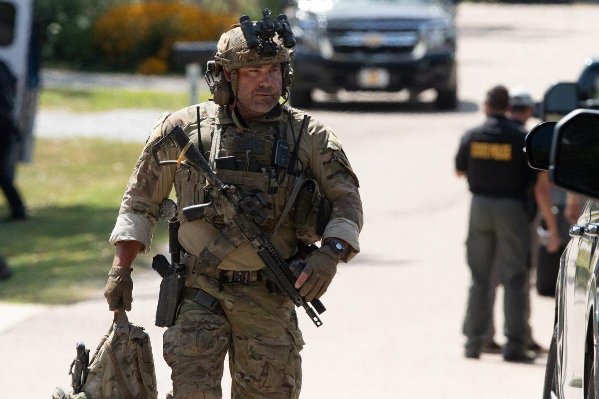 A SWAT officer leaves the scene of a standoff in the 1800 block of Meadow Court in Columbia, Ill.