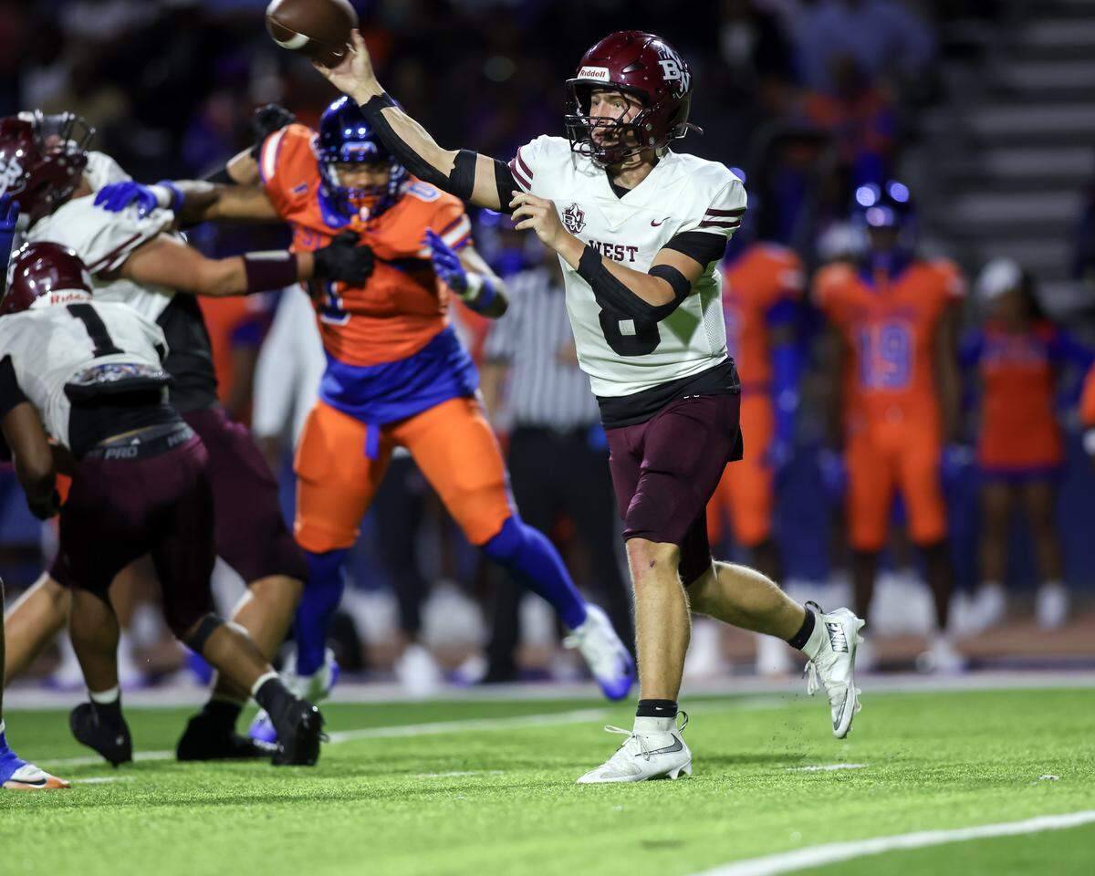Belleville West's Caiden Capell gets a pass off during Friday night’s Southwestern Conference game against East St. Louis.