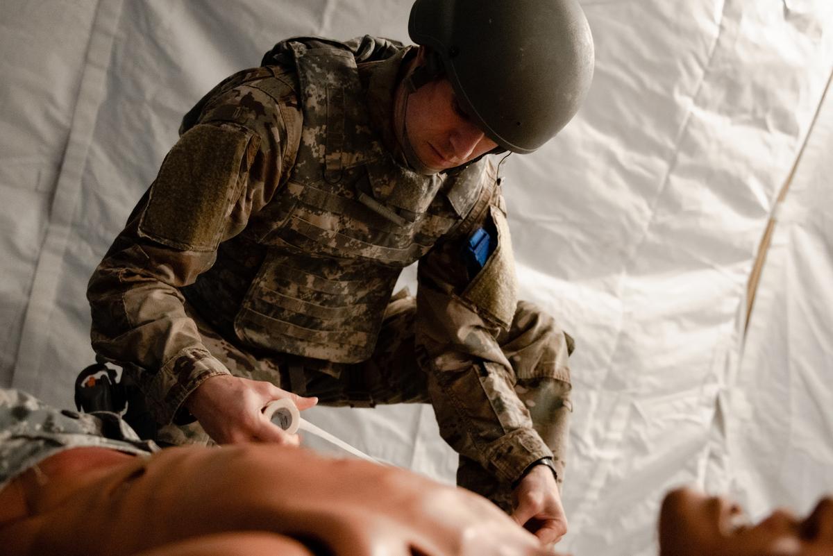 U.S. Air Force Maj. Adam Berheide, United States Transportation Command command sergeant, prepares to bandage mannequin during a Tactical Combat Casualty Care class on Scott Air Force Base. The Secretary of Defense has directed all servicemembers to be trained and proficient in basic life saving skills.