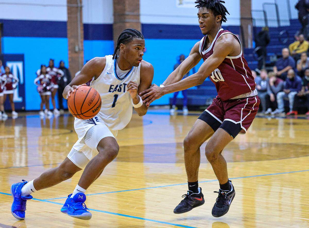 Belleville East Jordan Pickett’s drives to the basket against Belleville West’s David Marshall, Jr. during Friday night’s Southwestern Conference game. The Lancers ultimately prevailed 66-57.
