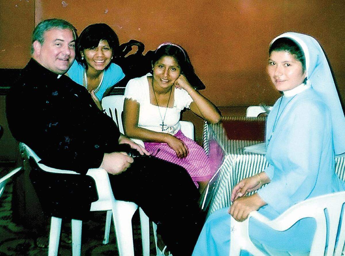 The Rev. Michael G. McGovern visits with a sisters and a youth at Santisimo Sacremento Catholic Parish in Piura, Peru.