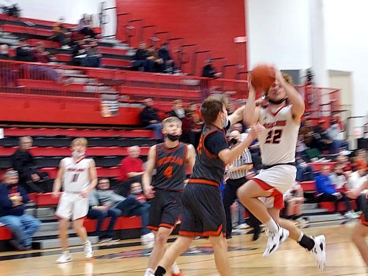 Highland junior guard Cade Altadonna goes up over a Wesclin defender for a shot during game two of the 30th annual Optimist Shootout in January at Highland High School. Altadonna and the Bulldogs finished the season strong and ended up with 14 victories.