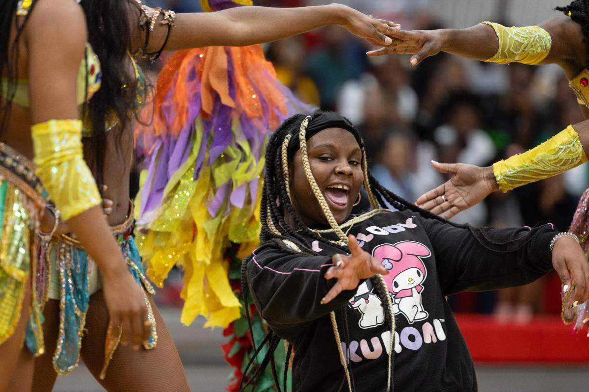A student from Mason-Clark Middle School limbos during the Carribean Carnival segment of the UniverSoul Circus on Aug. 14, 2024.