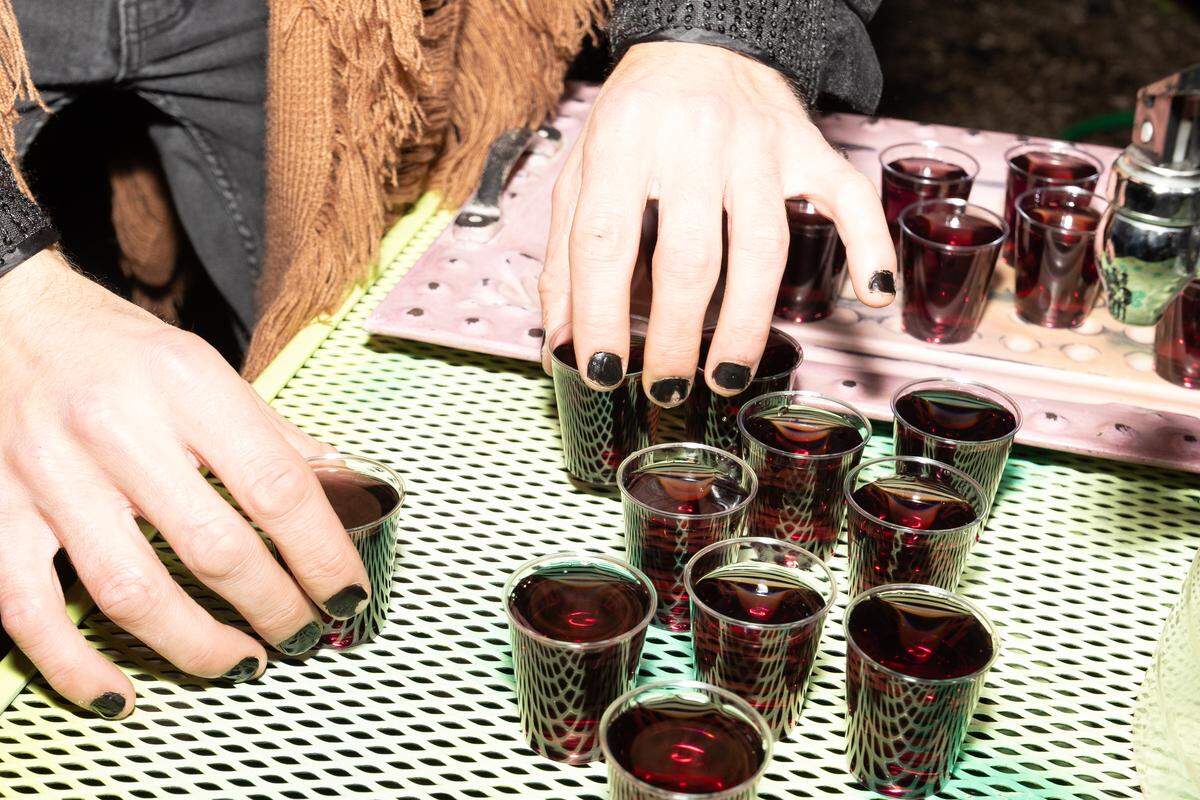 Spaces employee Landon Brooks sets out drinks in preparation for a midnight toast on Halloween.