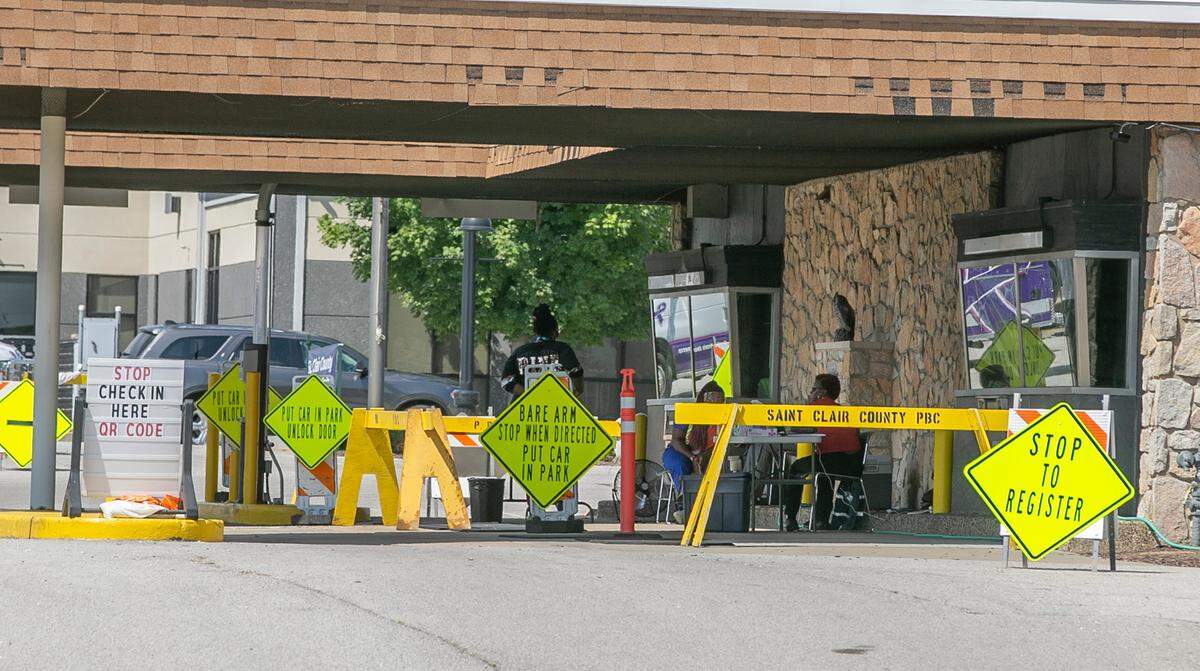 Workers at the St. Clair County Health Department sponsored vaccine clinic wait for patients in the shade of the building in August 2021. The department announced Wednesday morning the last day the clinic will be open is Thursday.