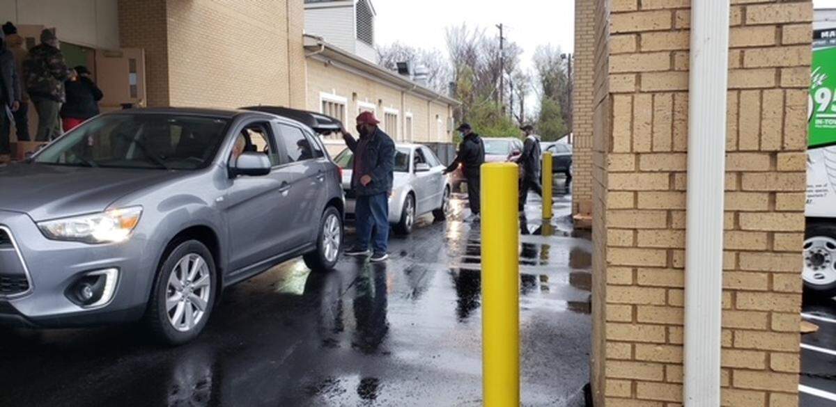 Volunteers with Morningstar Missionary Baptist Church in East St. Louis load cars with boxes of all the fixings for a Thanksgiving dinner on Nov. 14 after canceling the church’s annual sit-down community meal due to COVID-19.