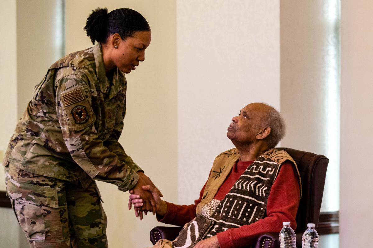 U.S. Air Force Senior Master Sgt. Lynnette Banks, 375th Wing Staff Agency senior enlisted leader, and Reginald Petty, a civil rights advocate, share a moment Jan. 12 during a “We” Have a Dream event on Scott Air Force Base. Petty met with members of Scott after the event to share stories and get photos together.