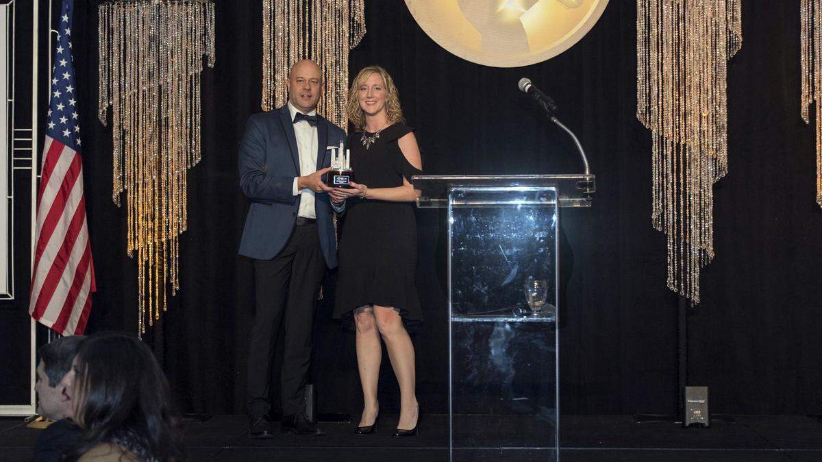 Sarah Deutch, community relations coordinator for the city of Waterloo, accepts an award for Best Festival or Event from Cory Jobe, director of the Illinois Office of Tourism, at the Illinois Excellence in Tourism Awards ceremony in Chicago on Feb. 26.