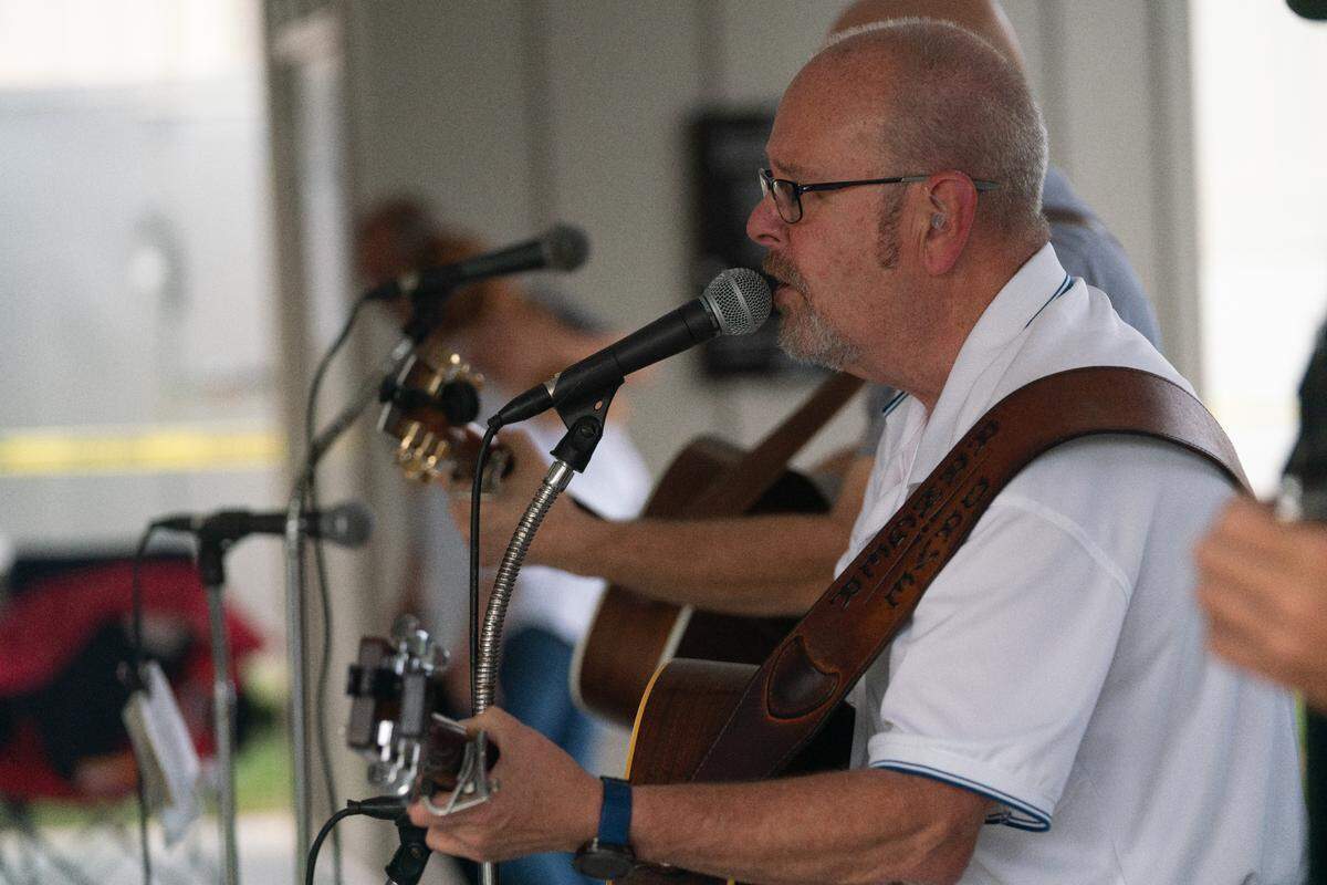 Members of the late George Portz’s bluegrass band play “Paradise” by John Prine during Shiloh, Ill.’s homecoming at Shiloh Community Park on Sept. 8, 2023.