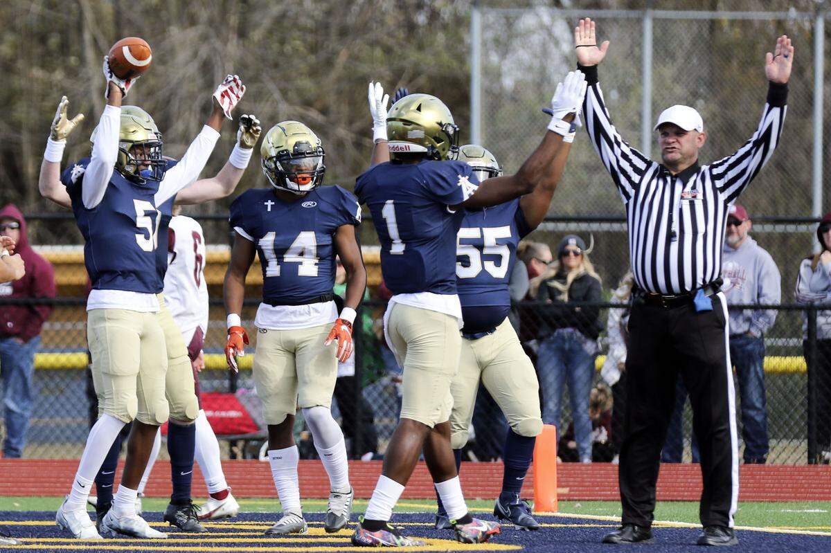 Althoff’s Jordan Lewis and his teammates celebrate after Lewis recovers the ball in the end zone putting Althoff on the board first during an IHSA Class 2A second round playoff game against Red Bud. The Crusaders prevailed 26-14 and now advance to the quarterfinal round.