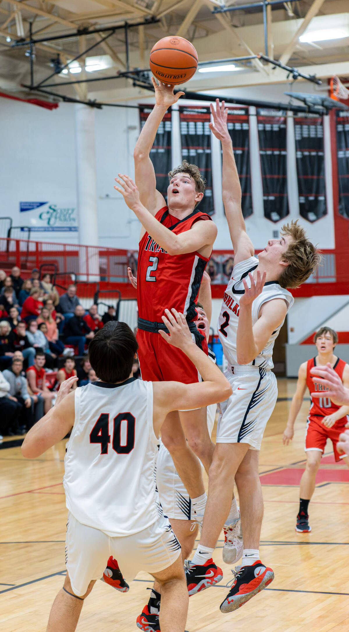 Triad’s Jake Stewart shoots over Highland’s Braxdon Decker during Friday night’s Mississippi Valley Conference game. The Knights ultimately posted a 50-37 victory.