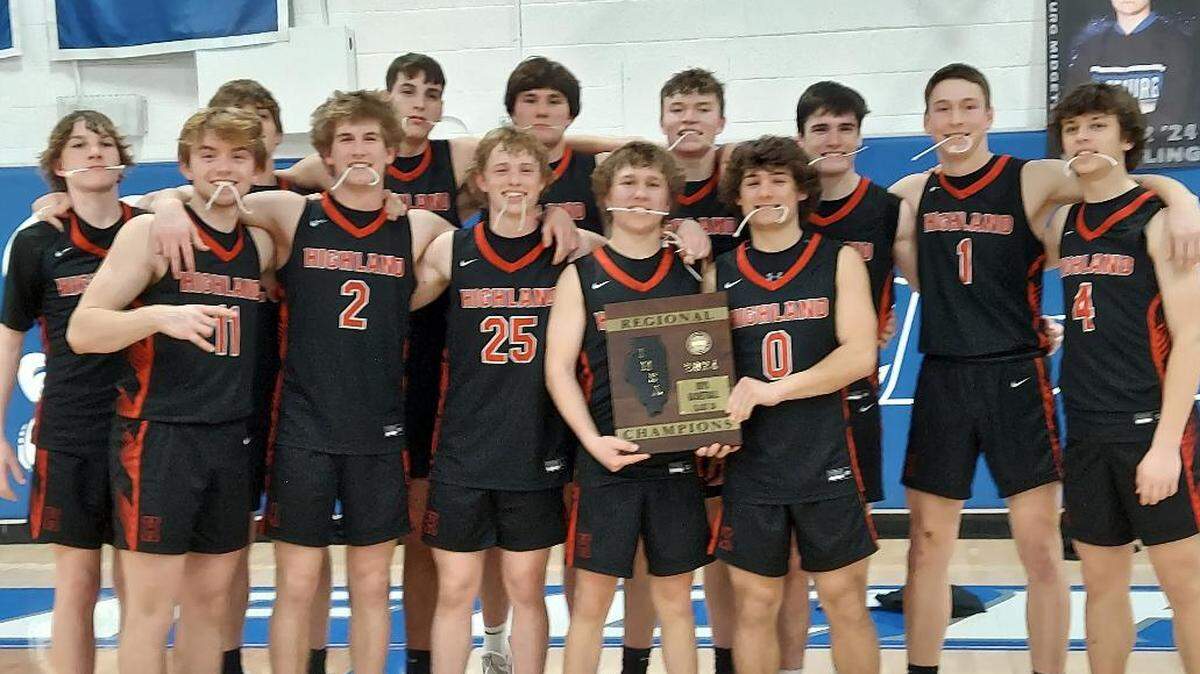 The Highland boys basketball team celebrates a victory over conference rival Mascoutah in the championship game for the Freeburg Class 3A Regional Tournament Friday night.