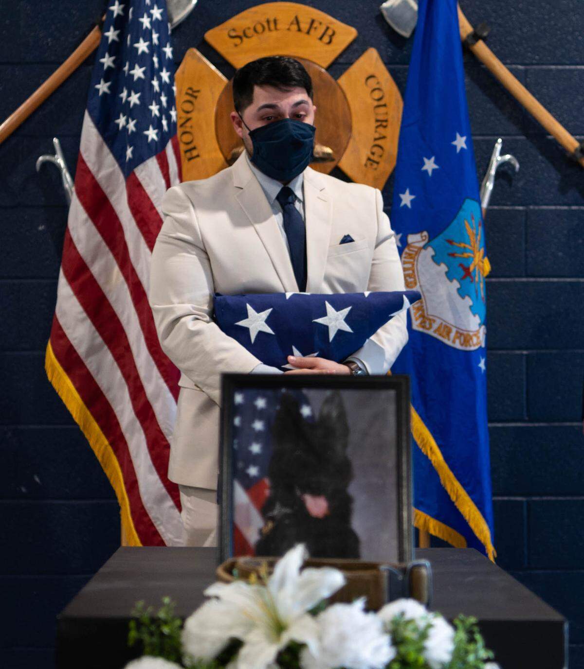 Frank Romero, former 375th Security Forces Squadron military working dog handler, mourns the loss of his partner, Kaso, during a memorial service on Scott Air Force Base. The hours Romero and Kaso spent training led them to have a very strong bond.