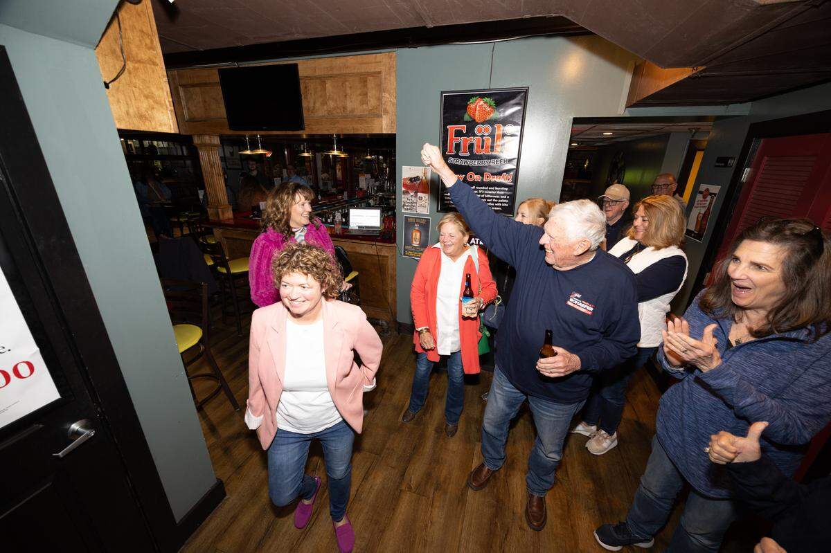 Belleville City Clerk Jenny Gain Meyer walks into an election watch party on Tuesday night at Tavern on Main restaurant and bar. Supporters had recently learned that she had been elected mayor.