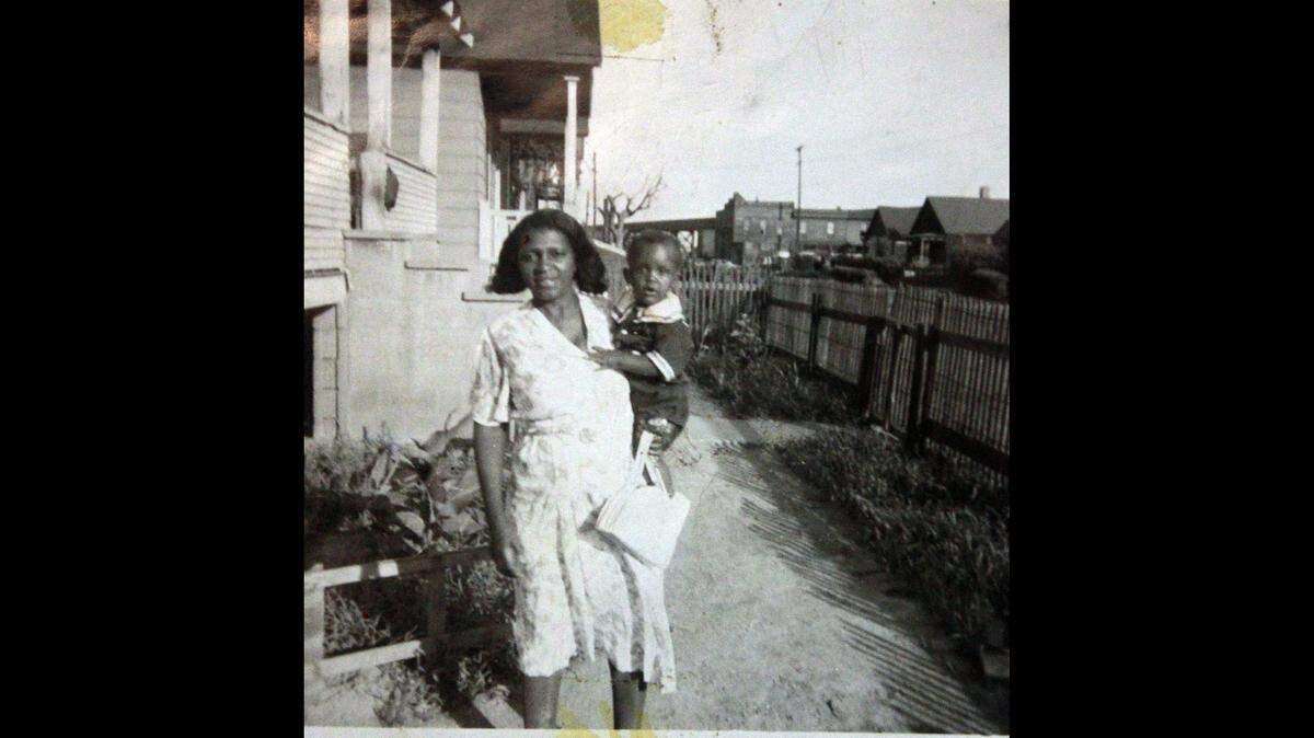 Mattie Malone holds son Michael in the early 1950s outside the East St. Louis bungalow where she lived for 69 years.