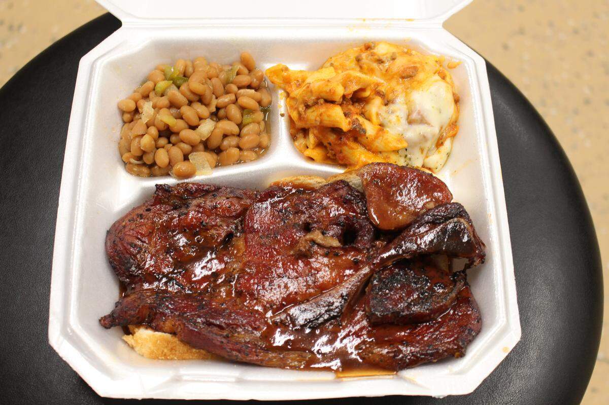 Good Heavens BBQ & Bakery in East St. Louis serves a pork steak plate with baked beans and mostaccioli for $9.50.