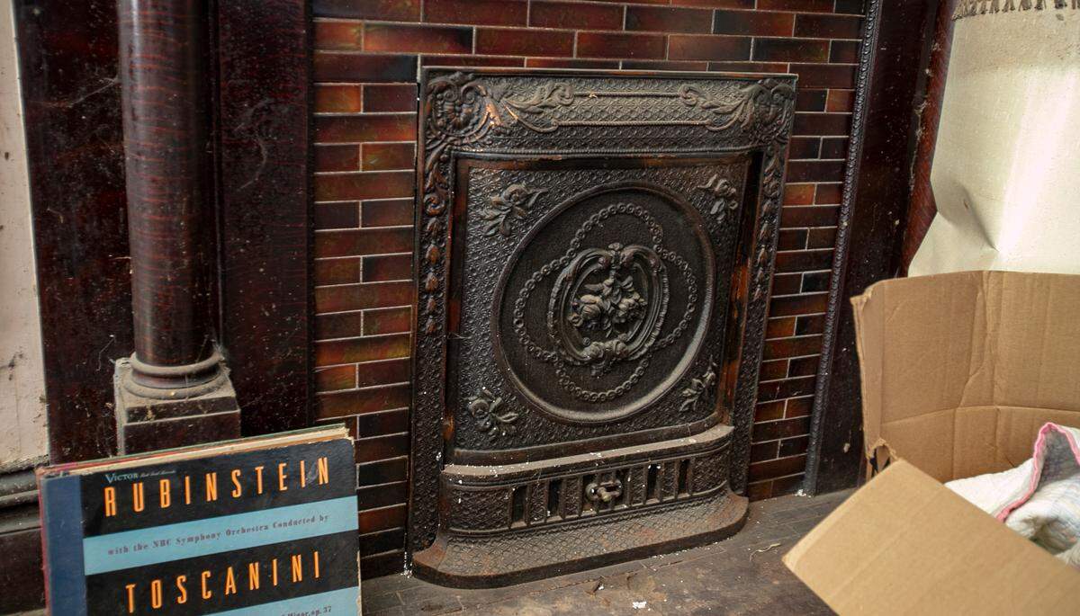 “The Pink House” in Aviston has a decorative fireplace against one wall in the parlor. It’s one of many original features that have been preserved by the home’s three owners in 114 years.