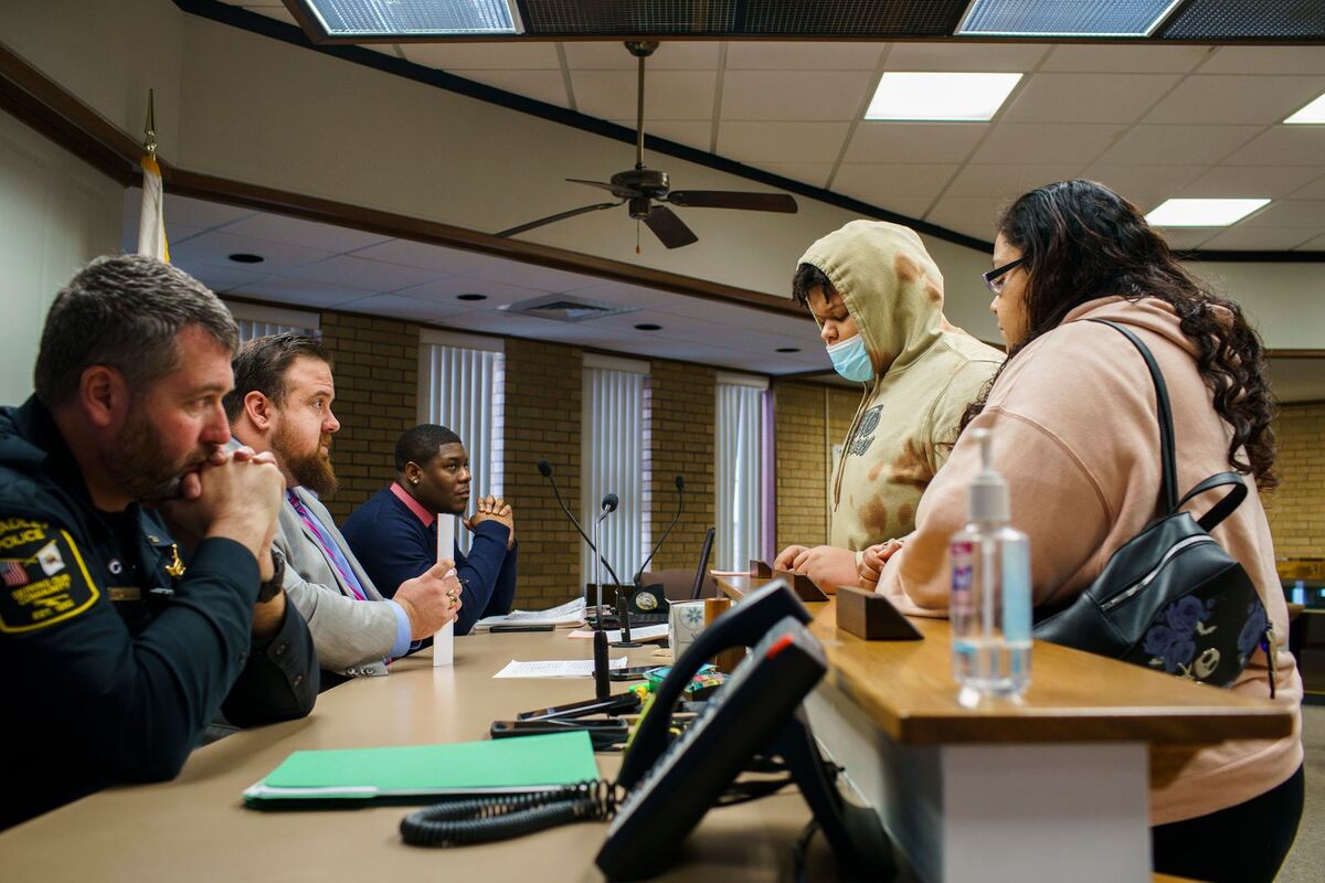 After 16-year-old Christian, center, was ticketed for possession of an electronic smoking device at school in Bradley, Illinois, he and his mother, Ashlee Dennison, far right, were called to a hearing where they faced a police lieutenant and two adjudication officials.