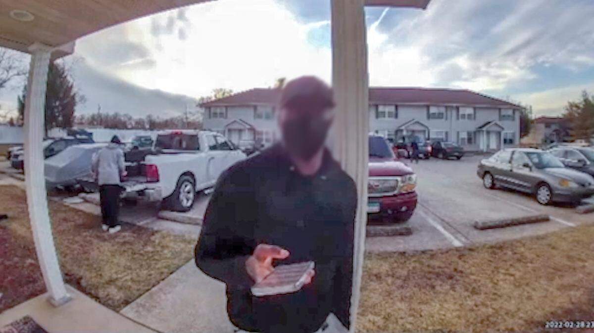 This still image from a Ring camera video shows a deliveryman outside a Fairview Heights apartment on Feb. 28. He was asking if residents had found a gun left in a Walmart grocery bag he delivered on Feb. 26.