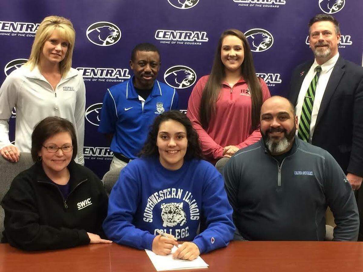 Sydney Irizarry signs up to play volleyball at Southwestern Illinois College in Belleville, surrounded by her parents, Chistina “Tina” and Andre Irizarry, and school officials.