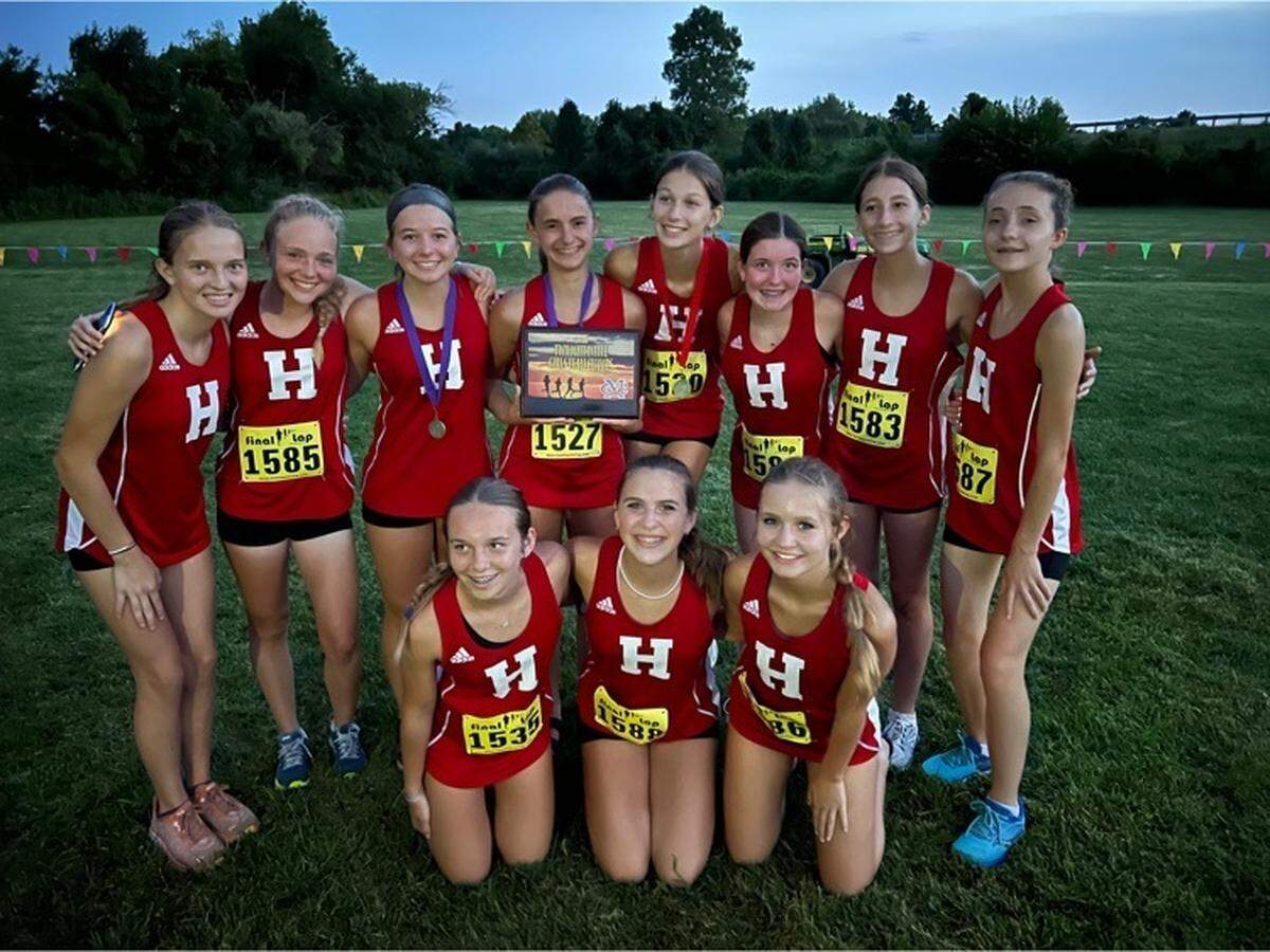 The Highland High School boys and girls cross country teams lived up to preseason expectations as they both earned first place honors at the Twilight Invitational hosted by Civic Memorial at the Bethalto Sports Complex on Saturday, Aug. 27. The girls team is pictured here with their first place trophy.