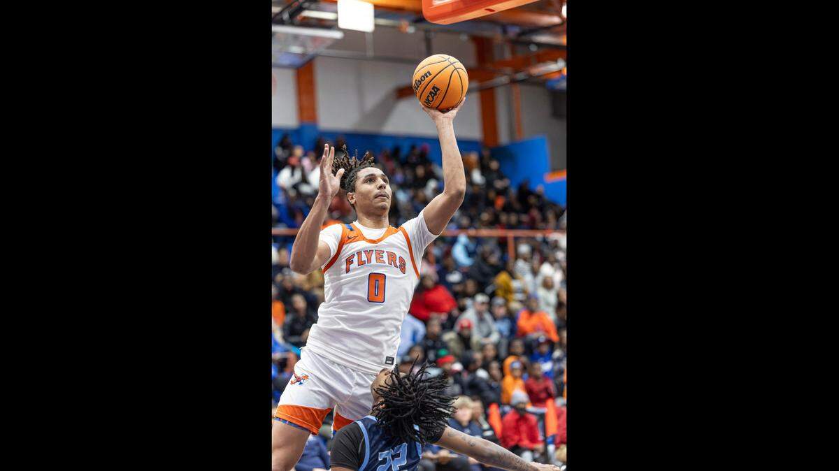 Jamison White goes hard to the basket for two of his 20 points against Belleville East.