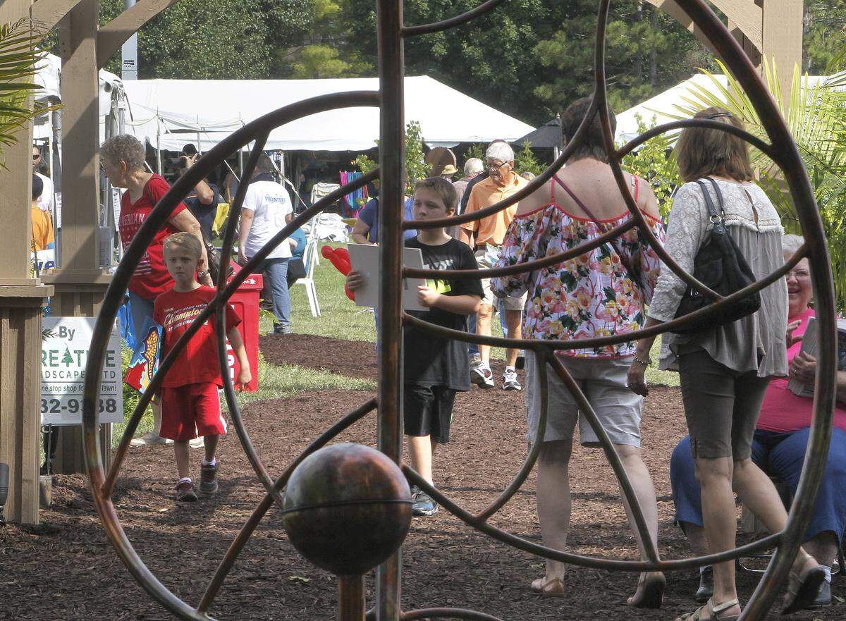 Patrons of the Salute to the Arts in 2016 are seen through a copper and stainless steel sculpture by local metal artist Kevin Trobaugh. Trobaugh is one of the many artists who will be returning to this year’s event. midwestsalute.com