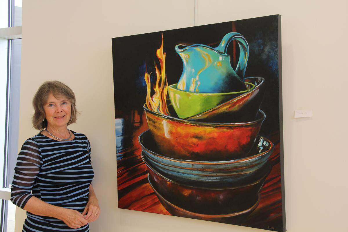 The works of realist painter Martha Iler, pictured with her piece “Invitation,” can be seen on display at Kaskaskia College Dr. Dee and Sue Boswell Art Gallery through Dec. 4. 