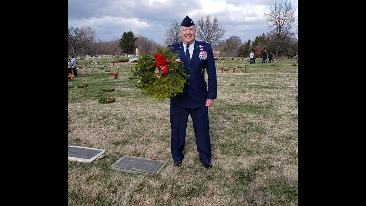 John “Woody” Almind places a special wreath in honor of retired Lt. Col. Jose Mendez, who died Dec. 1, 2020.