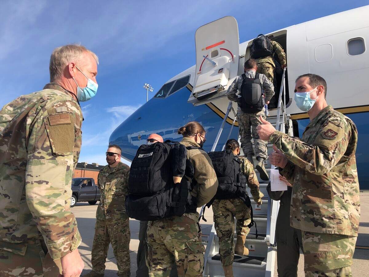 Master Sgt. Blair Bookland (left) and members of the 932nd Medical Group board a 932nd Airlift Wing C-40C aircraft on April 22 at Scott Air Force Base to support COVID-19 relief efforts in New York. The 932nd MDG commander, Col. Chris Spinelli (right) says farewell and gives his medical staff the “thumbs up” sign as they depart. This latest deployment brings the total of Air Force Reservists mobilized in support of COVID-19 relief efforts to more than 770 around the nation.