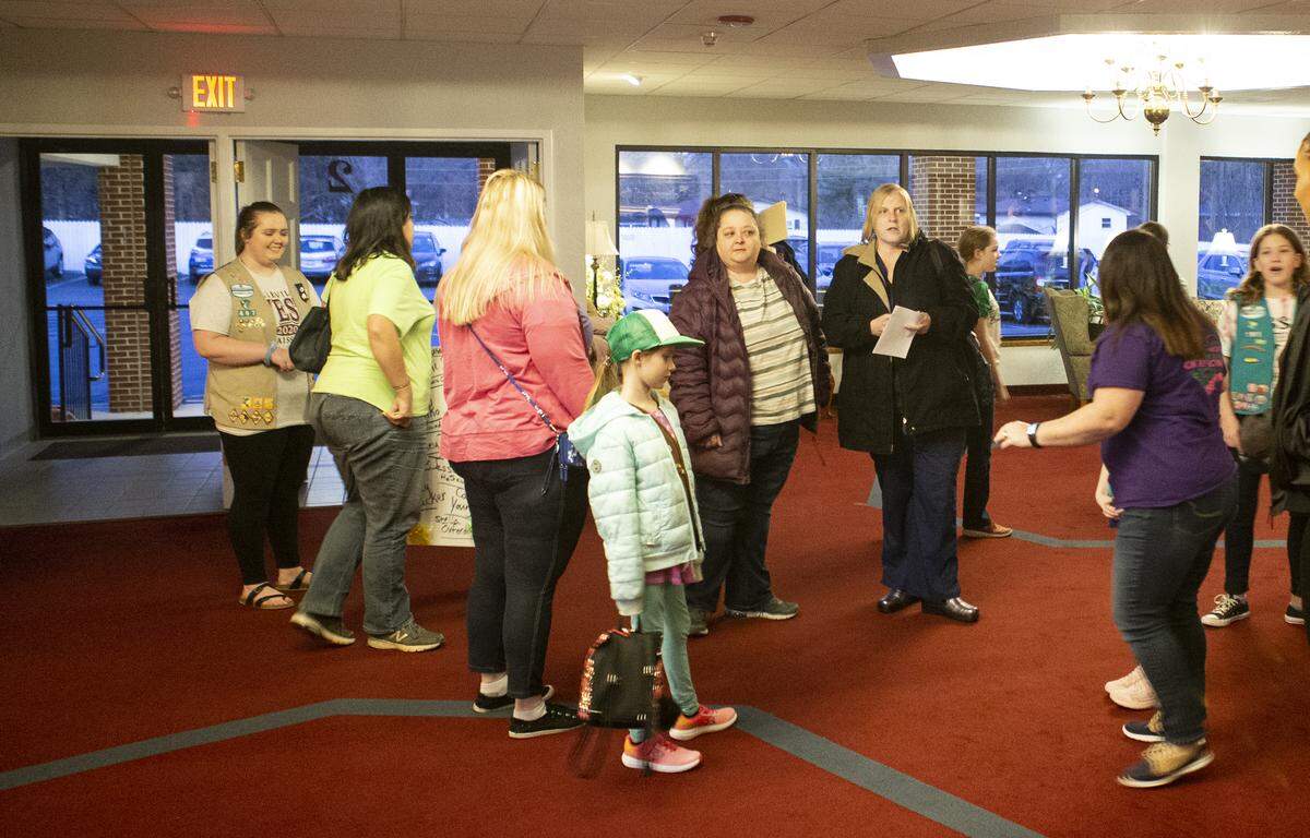 Girl Scouts, leaders and parents arrive at a meeting Thursday night at St. Matthew United Methodist Church in Belleville to discuss the proposed sale of four camps owned by Girl Scouts of Southern Illinois.