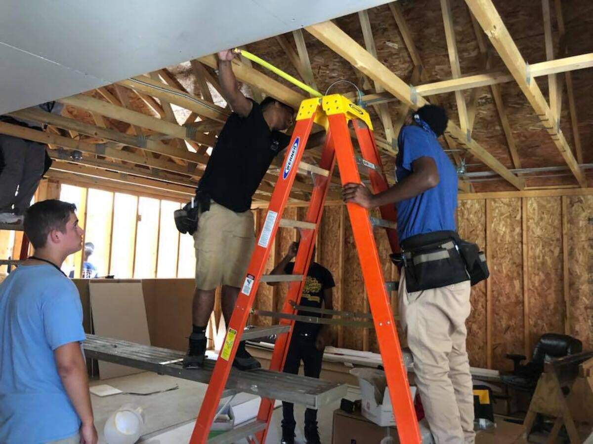 Belleville East students in the building trades program work on the early stages of the girl softball team’s 30-person locker room.
