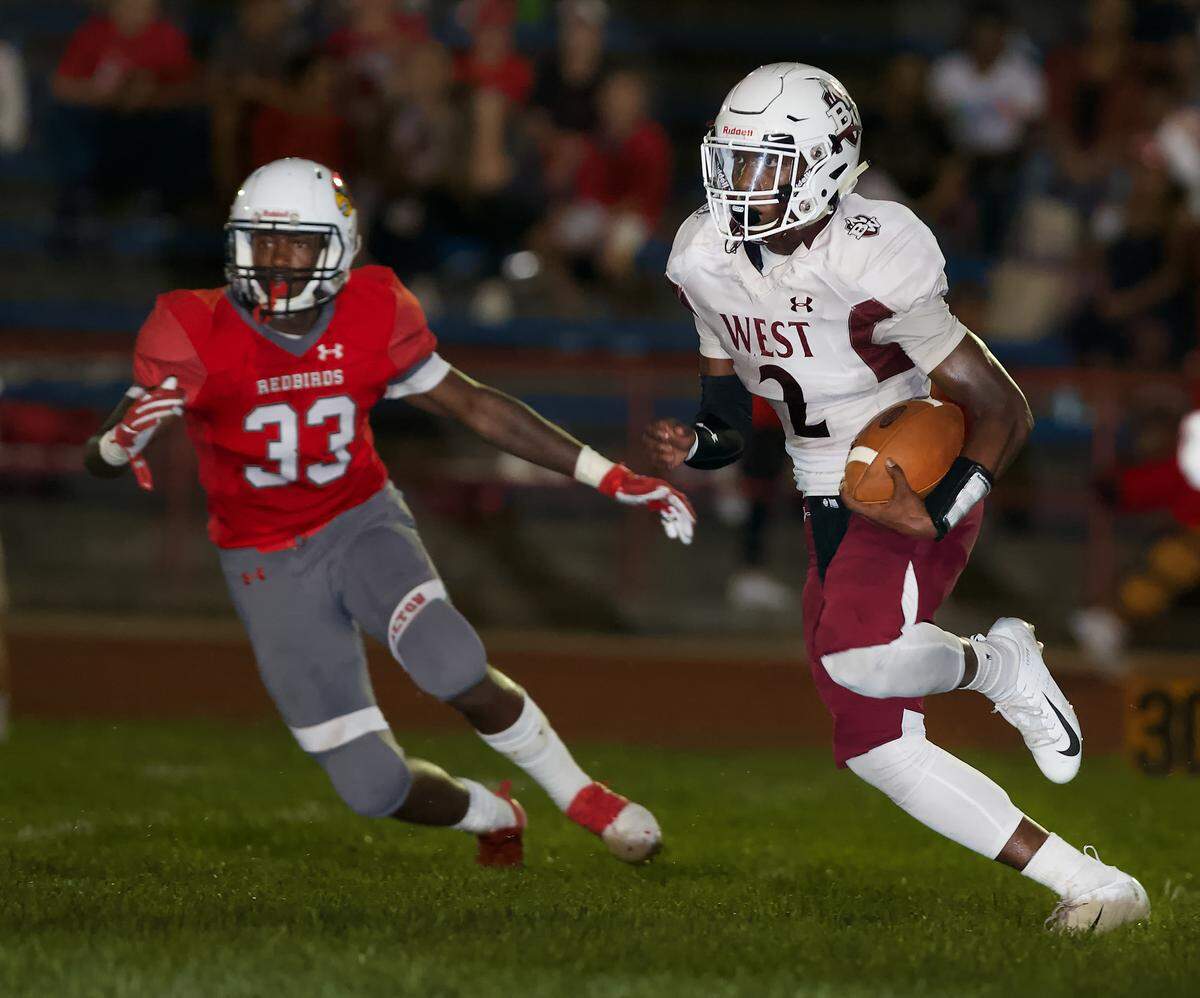 Belleville West Clarence Davis looks for and opening during Friday’s game.