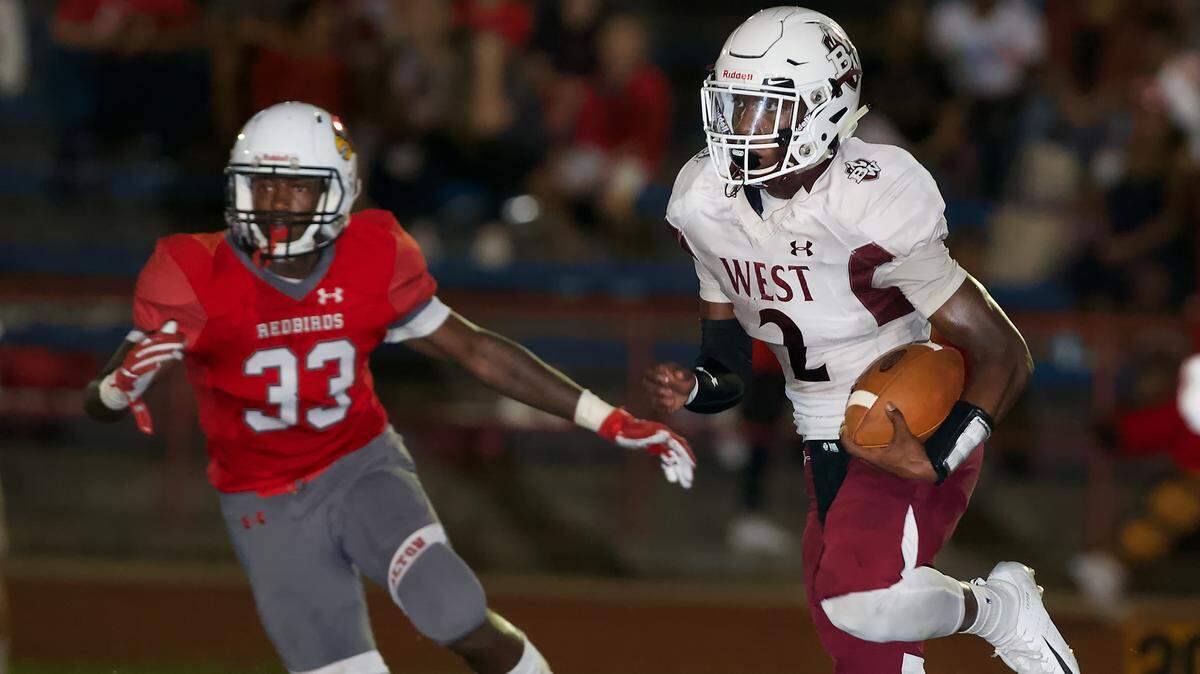 Belleville West Clarence Davis looks for and opening during Friday’s game.
