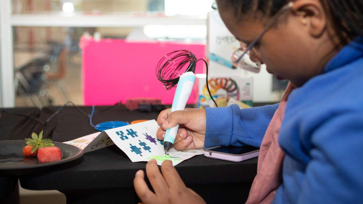 Samantha Burris colors in puzzle piece during 2025’s annual “Spring Family Forum,” a showcase for East St. Louis School District 189’s After School 21st Century Programs. Five of these programs may close at the end of June 2025 should another funding source not be secured.
