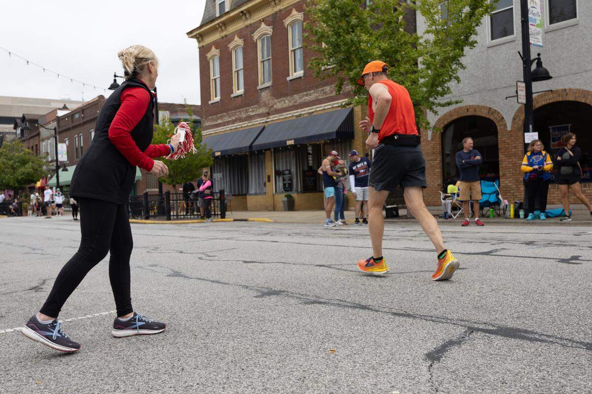A member of the Belleville Running Club cheers on a participant at the Belleville Marathon on Sept. 28, 2024.