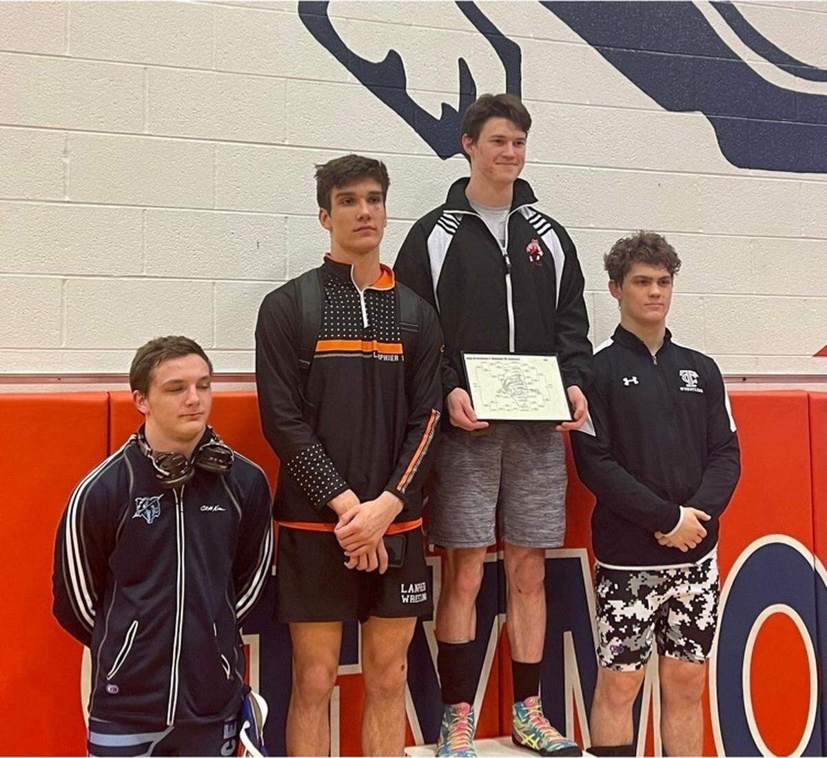 Highland’s Benny Mitchell, top right, stands on the medal stand after winning the 160-pound championship in the IHSA Class 2A sectionals at Mahomet-Seymour on Saturday, Feb. 12.