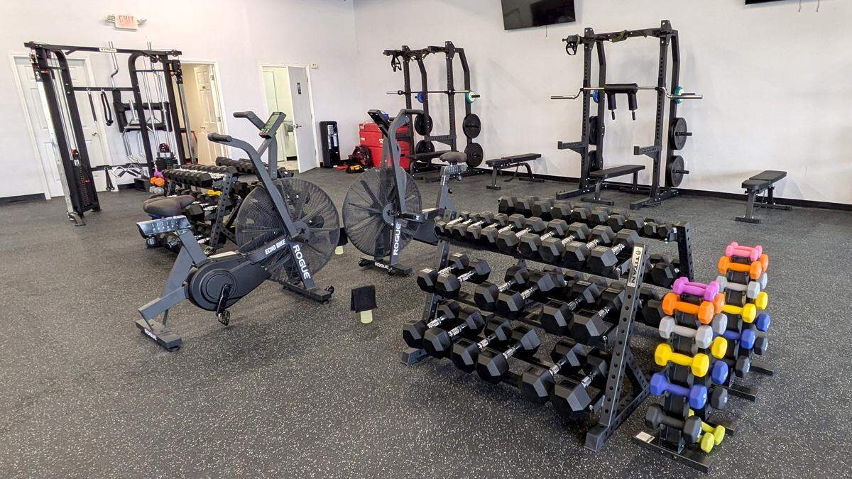 Equipment at I-Koach Fitness includes stationary bikes, hand weights and Smith machines.