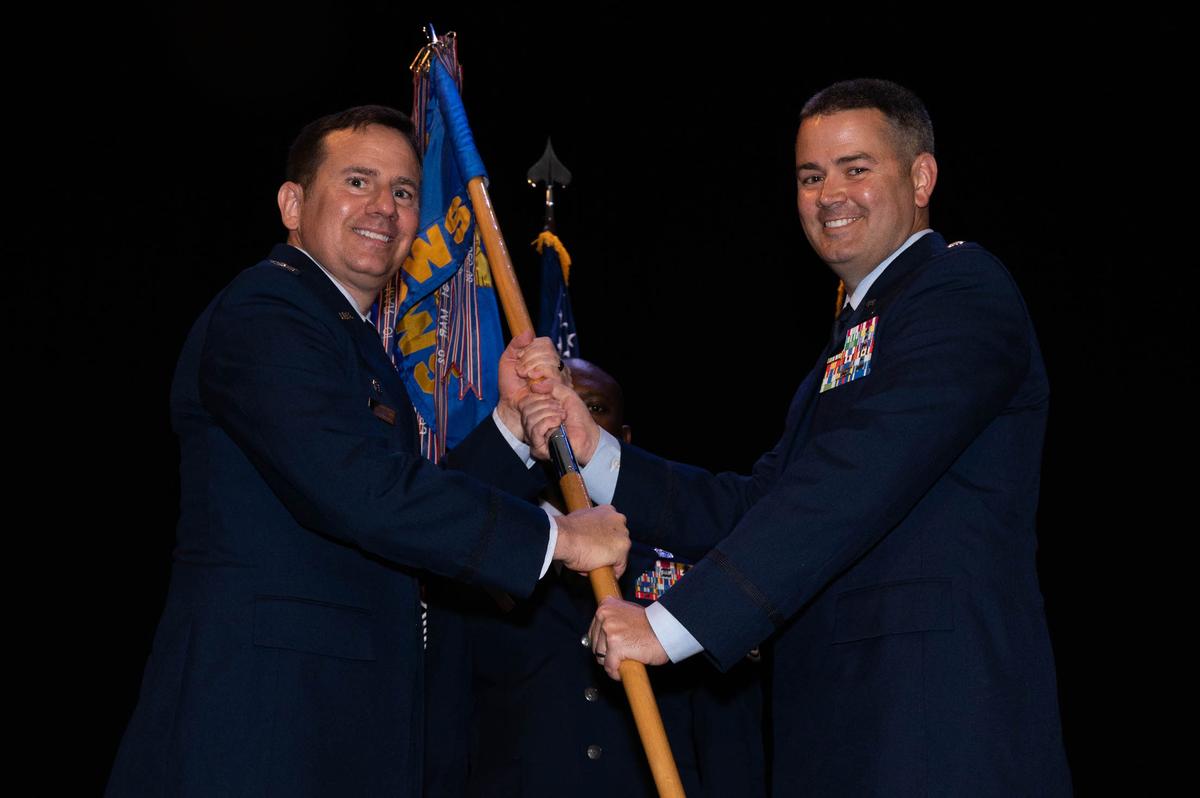 U.S. Air Force Lt. Col. Justin Puckett, 15th Operational Weather Squadron incoming commander, assumes command of the 15th OWS after receiving the guidon from Col. Damon Vorhees, 1st Weather Group commander, on Scott Air Force Base. Puckett previously served as an international program officer at the Defense Threat Reduction Agency, Fort Belvoir, Virginia.