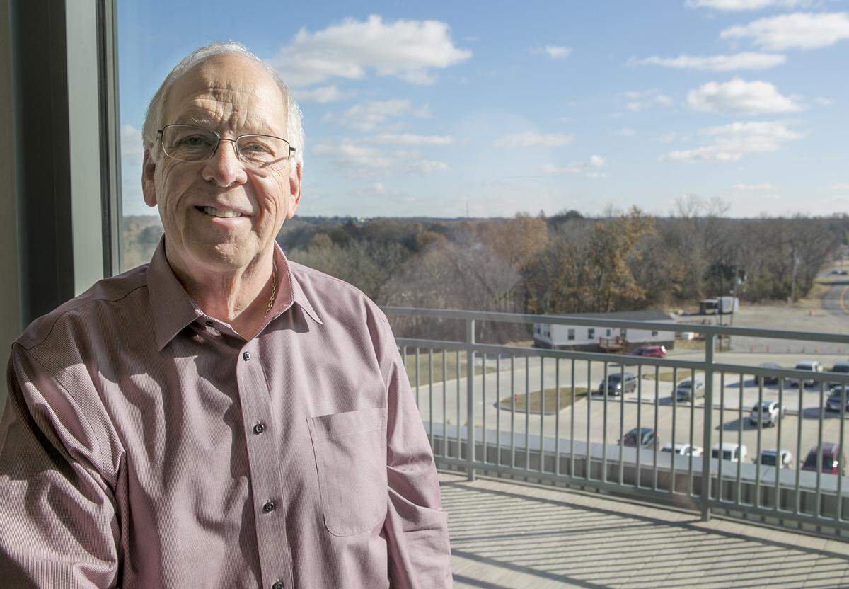 Developer Joe Koppeis is shown in his window-lined office on the fifth-floor of the new 11 South medical and office complex in Columbia.
