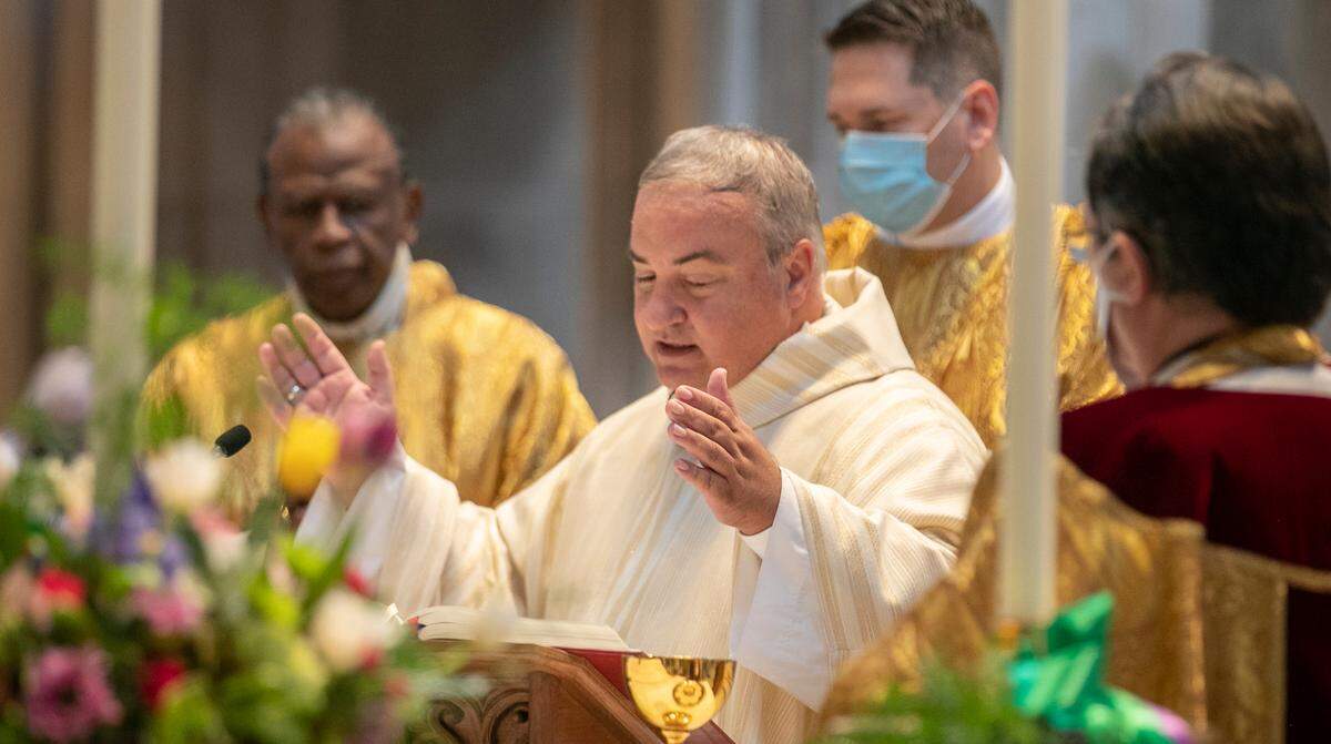 Bishop Michael G. McGovern is shown during his Mass of ordination and installation as the ninth bishop of the Catholic Diocese of Belleville on Wednesday at the Cathedral of St. Peter in Belleville. He’s replacing Bishop Edward K. Braxton, left.