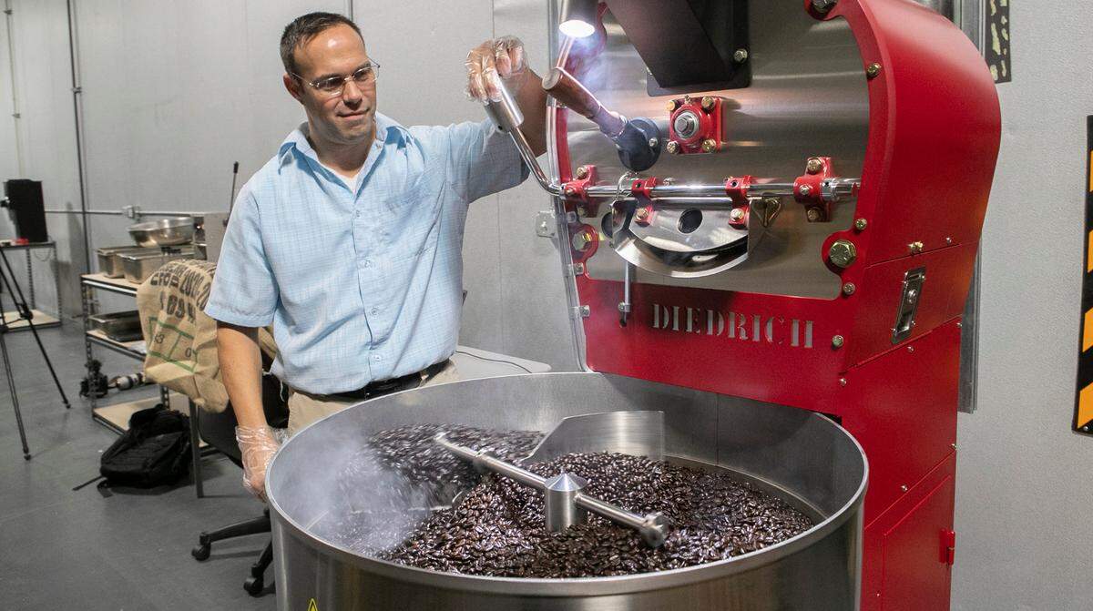 Kyle Clark, CEO Heart2Heart Coffee, roasts a batch of coffee in a Diedrich IR-5 roaster.