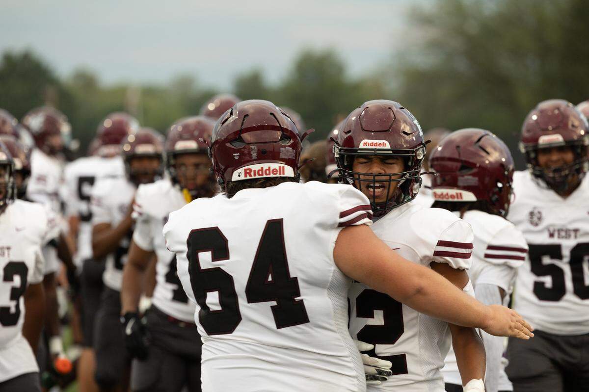 Belleville West Maroon players celebrate their first touchdown during the first game of the season against Mascoutah on Aug. 30, 2024.