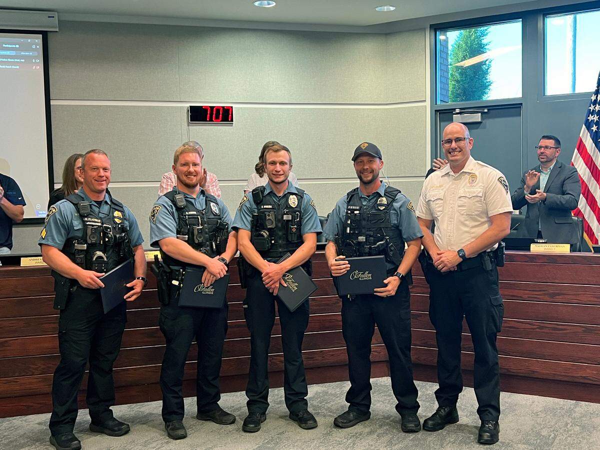 Sergeant Matt Plassman and Patrolmen Chad Finnan, Kenneth Morris, and Michael Shewmaker with Police Chief Kirk Brueggeman.