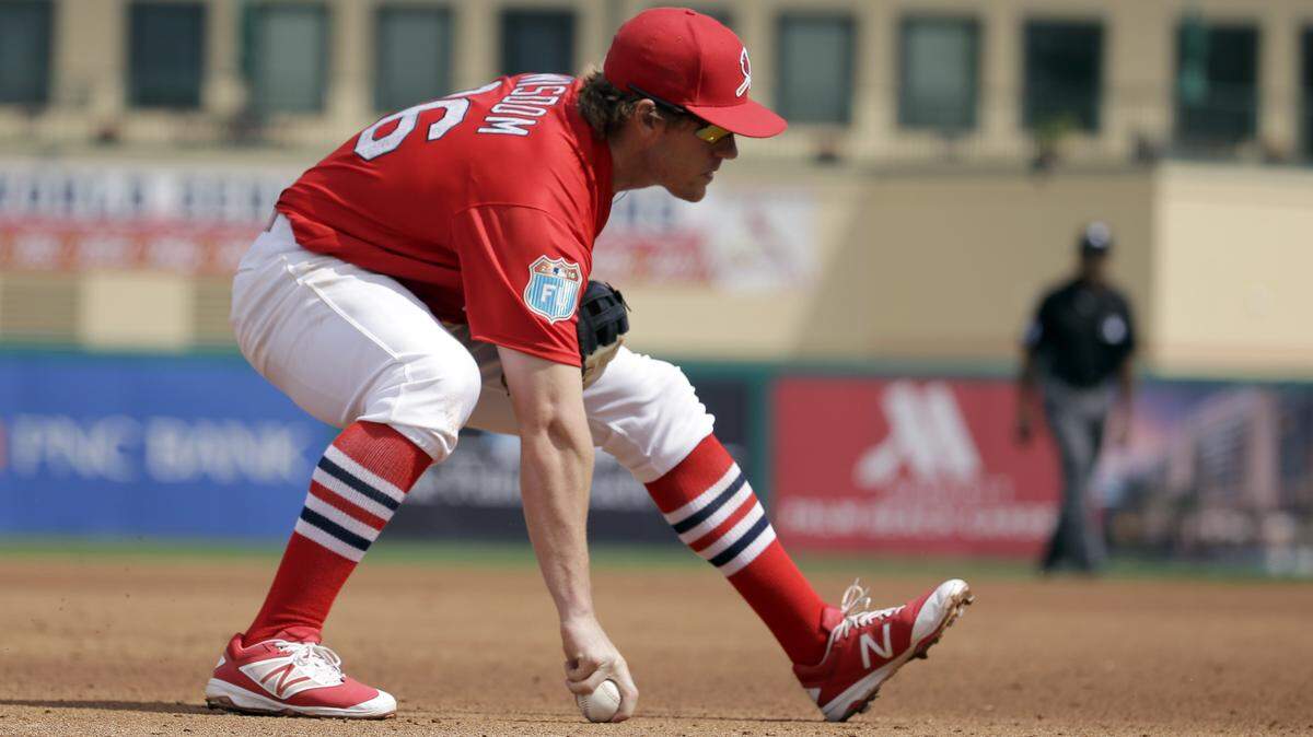 St. Louis Cardinals third baseman Patrick Wisdom picks up a ball hit by New York Mets’ Travis Taijeron during the fourth inning of an exhibition spring training baseball game Monday, March 7, 2016, in Jupiter, Fla. (AP Photo/Jeff Roberson) 