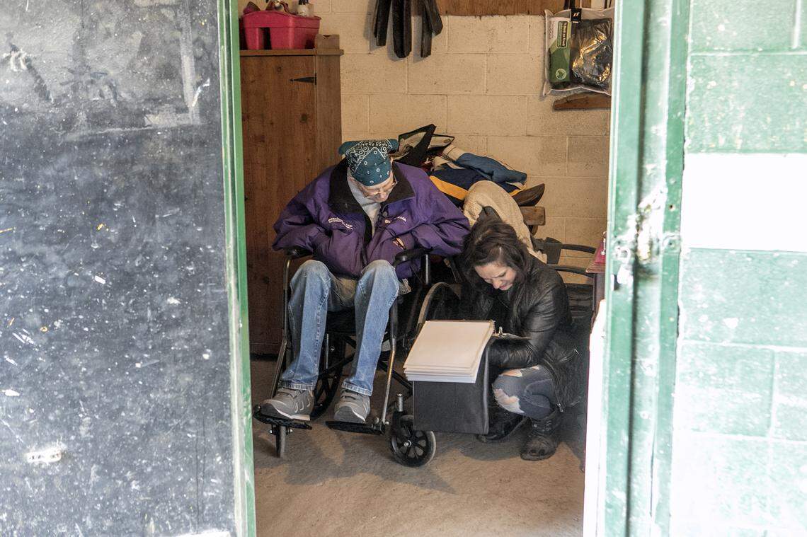 John Brown and Christine Ellis-Randazzo look through a photo book. Brown’s favorite horse, Dreymore, was owned by Ellis-Randazzo. Brown, 60, is a lifelong horseman, working as a trainer and a groom and in any other capacity he could find around horses since he was a child.  For decades he worked at Fairmount Racetrack in Collinsville, caring for and training racehorses.