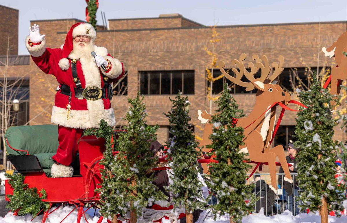 Santa waves to the crowd during the parade.