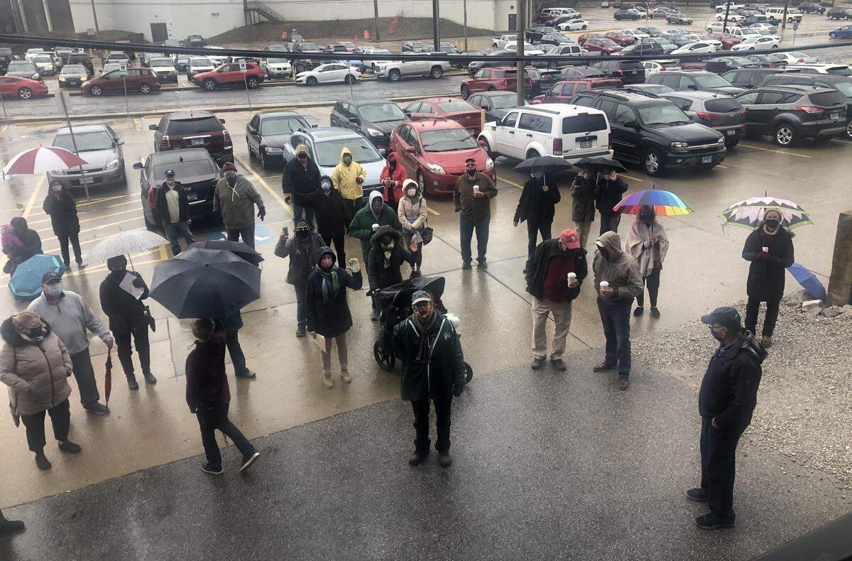 Customers of Sacred Grounds Cafe in Edwardsville stood outside in the rain on Wednesday to say goodbye to owner Jenn Courtney, who’s selling the business.