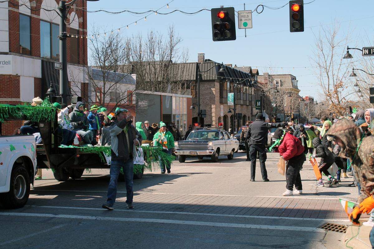 Belleville’s St. Patrick’s Day Parade begins traveling down Main Street on Saturday, March 12, 2022, with a float and Illinois State Police cruisers at the front as spectators grab candy and beads. The annual event is hosted by the Ancient Order of the Hibernians and will take place again Saturday, March 11.