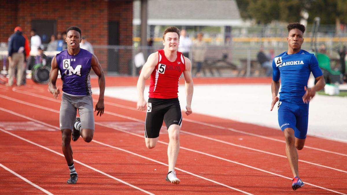 Highland senior Seby Wolf runs between Mascoutah 's Kourtney Jackson, left, and Cahokia's Darreon West en route to placing second to West while Jackson wound up third in the 100-meter dash at the Military Classic Friday at Mascoutah High School.